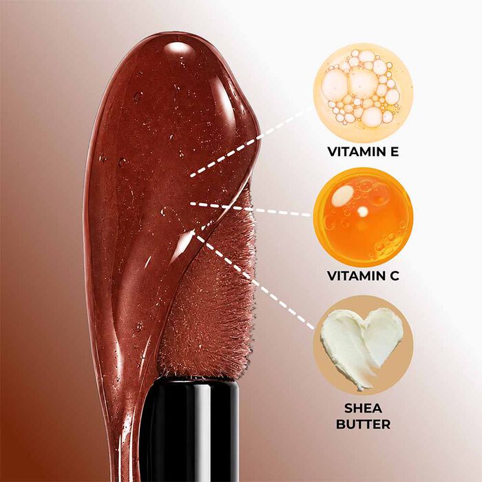 Applying Hot Kiss Brown Sugar Lip Plumper to lips for long-lasting volume, shine, and a fuller-looking pout.